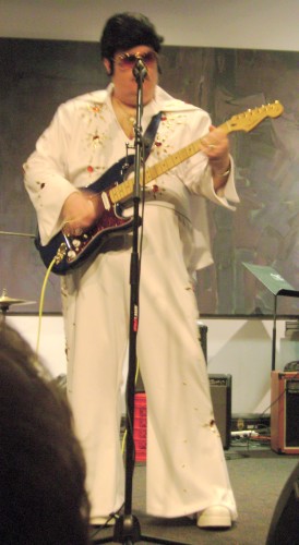 photo of Jim in an Elvis costume with jumpsuit, cape, wig, and platform shoes